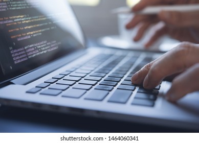 Web Or Application Development, Business And Technology Concept. Programmer, Man Software Developer Hands Coding HTML, Programming Javascript On Laptop Computer Screen, Back View Close Up