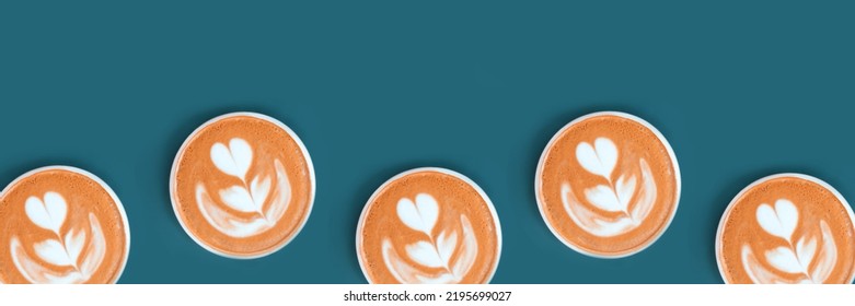 Web banner with cappuccino with frothy foam, coffee cup top view is on the blue background. Flat lay style. Copy space, cut out. Pattern.
