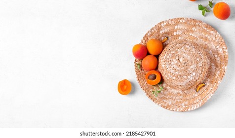 Web Banner With Ripe Apricots On Straw Hat On White Background. Farm Fruit Harvest. Mockup With Copy Space