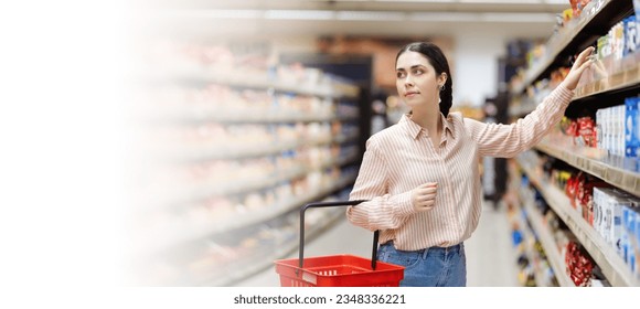 Web banner of shopping in supermarket. Portrait of young attractive caucasian woman takes food from shelve. Copy space. Concept of consumerism. - Shutterstock ID 2348336221
