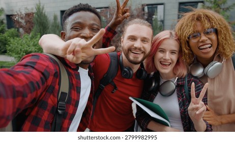 Web cam view four multiracial university students happy smiling cuddle posing looking at camera in city group of diversity friends diversity buddies smile cuddling together outdoors for selfie photo