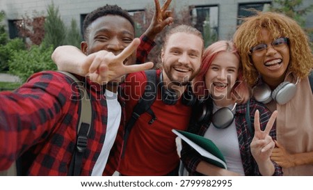 Web cam view four multiracial university students happy smiling cuddle posing looking at camera in city group of diversity friends diversity buddies smile cuddling together outdoors for selfie photo