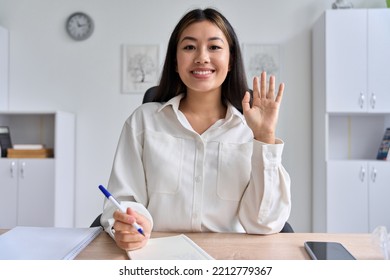 Web Cam View On Young Asian Business Woman With Toothy Smile Waving Hands Making Video Call For Remote Job Interview Or Start Online Lesson Business Training. Telework, E-learning Concept