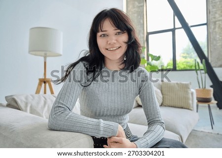 Web cam view of young smiling woman looking in camera, online meeting, video call