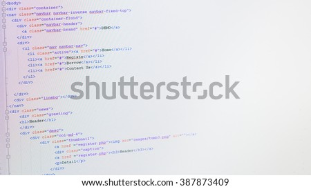 Web coding on developer computer screen with selective focus on div element.