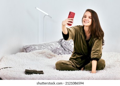 Web Conference By Smiling Woman Using Handy While Sits In Bed.