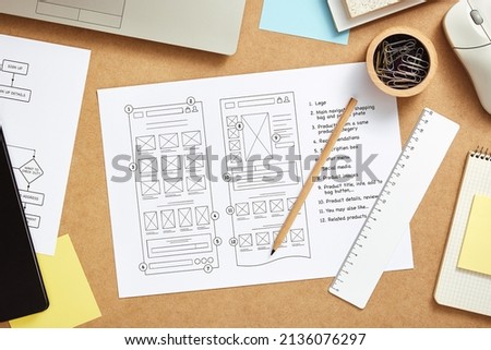 Web design concept. Web designer desk with website wireframe sketches and user flow. Top view