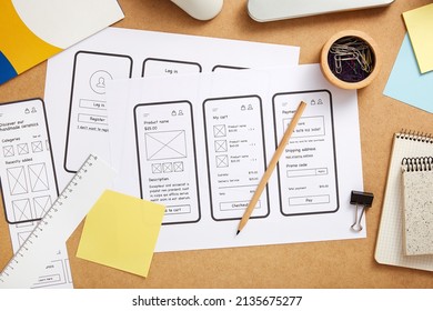 Web Design Concept. Several Mobile App Wireframe Sketches Over Product Designer Desk. Top View.