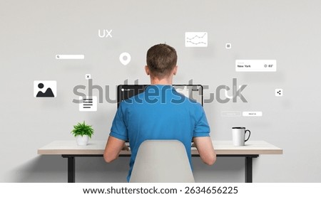 Web designer or developer seated in front of a laptop, seen from behind, actively working on a site interface. Around the desk float various UI elements