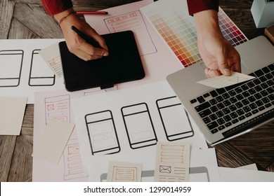 Web designer planning application for mobile phone. Design application development draft sketch drawing online Technology Content.User experience concept.