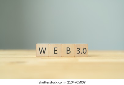 Web development, the next generation of internet, Web 3.0 concept. Futuristic technology for  better of human life.  Painted black word Web 3.0 on wooden cubes with beautiful grey background. Banner.