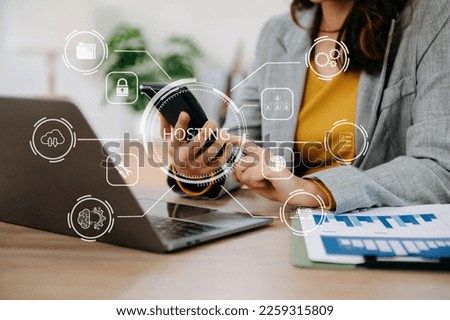Web hosting concept, woman using computer, tablet and presses his finger on the virtual screen inscription Hosting on desk, Internet, business, digital technology concept. in office


