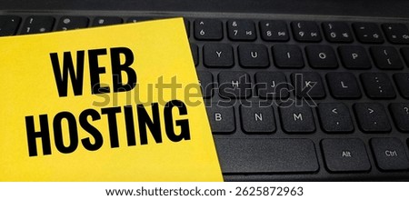 Web Hosting Text on Yellow Paper Placed on Computer Keyboard – Conceptual Technology Image Representing Internet Services, Online Server, and Website Management. 