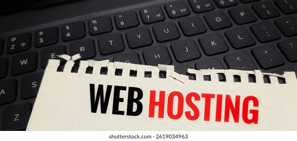 Web Hosting text printed on a piece of paper placed on computer keyboard, internet server concept, domain hosting service, website management and technology. 