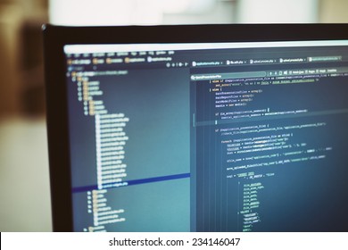 Web site codes on computer monitor. developer working on web sites codes in office.