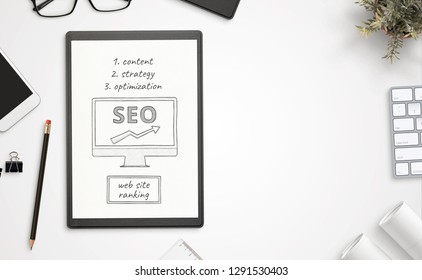 Web site optimization for search engine goals  on paper. Top view, office desk composition with free space for text.