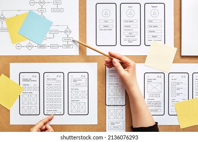 Web UX designer working on mobile responsive website. Flat lay image of numerous app wireframe sketches and user flow over product designer desk.  - Shutterstock ID 2136076293