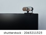 Webcam above computer screen. Black webcam above black screen. Digital security concept