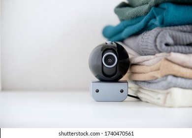 Webcam Hidden In A Stack Of Clothes For Covert Surveillance Of The House. Surveillance And Security Systems. Smart House. Espionage. Hidden Camera For Watching