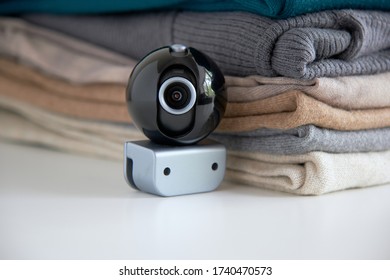 Webcam Hidden In A Stack Of Clothes For Covert Surveillance Of The House. Surveillance And Security Systems. Smart House. Espionage. Hidden Camera For Watching