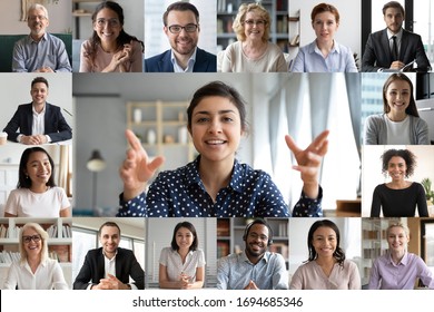 Webcam laptop screen view many faces of diverse people involved in group videoconference on-line meeting lead by indian businesswoman leader, team using video call app work solve common issues concept - Shutterstock ID 1694685346