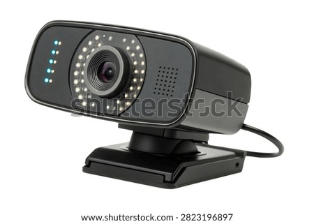  a webcam mounted on a small black base. The webcam has a sleek, modern design with a circular lens surrounded by an array of small white lights