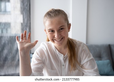 Webcam View Of Blonde Teenager Greeting To Camera In A Video Call.