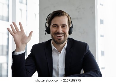 Webcam View Businessman Sit At Workplace Desk Looks At Camera Wave Hand Greets Client, Start Videoconference Communication, Take Part In Remote Chat, Use Video Call App. Virtual Negotiations Concept