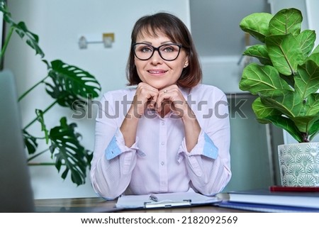 Webcam view of middle aged talking female in home office Stock photo © 