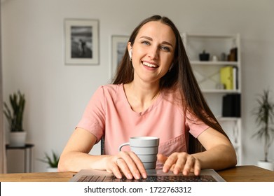 Webcam View Of Young Happy Woman In Casual Wear At Home, She Typing On The Keyboard With A Smile On The Face And Watching On The Screen. Front View