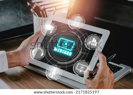 Webinar e-learning training business internet technology concept. Person hand using digital tablet with VR screen webinar icon on office desk.