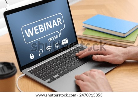 Webinar. Man using laptop at table, closeup