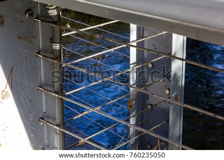 Webs covering a metal railing