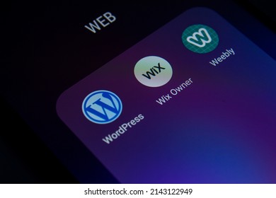 Website builders application icons on smartphone screen. WordPress, Wix and Weebly android apps. Afyonkarahisar, Turkey - April 5, 2022.