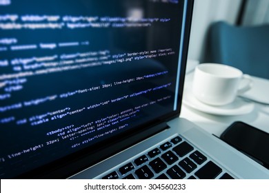 Website Coding. Website HTML Code On The Laptop Display Closeup Photo. Webdesigner Workstation.