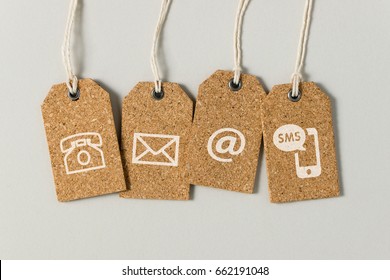 Website Contact Us Icons On Brown Tags Over Grey Background