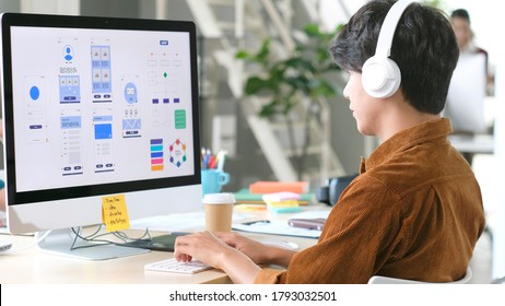 Website designer, Creative planning phone app development template layout framework wireframe design, User experience concept, Young asian man UX designer working on smartphone application at office - Shutterstock ID 1793032501