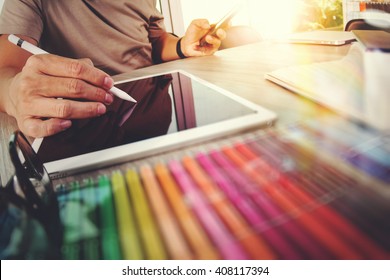 Website designer working digital tablet and computer laptop with smart phone and graphics design diagram, work from home as concept