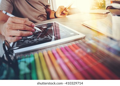 Website Designer Working Digital Tablet And Computer Laptop With Smart Phone And Graphics Design Diagram On Wooden Desk As Concept