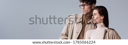 website header of fashionable couple looking away isolated on grey