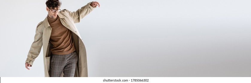 website header of fashionable man balancing while posing on grey - Shutterstock ID 1785066302