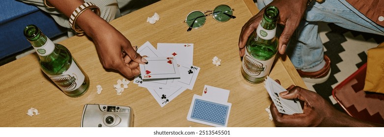 Website header of unrecognizable people playing cards on wooden coffee table