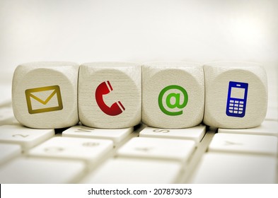 Website and Internet contact us page concept with colored icons on cubes on a keyboard - Shutterstock ID 207873073