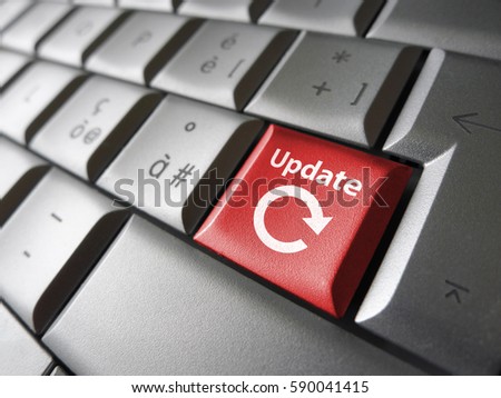 Website and Internet update concept with icon and sign on a red laptop computer key.