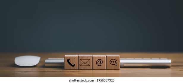 Website page contact us or e-mail marketing concept, Customer support hotline Contact us people connection. cube wood with the email, call phone, address, Chat message icons. on keyboard computer. - Shutterstock ID 1958537320