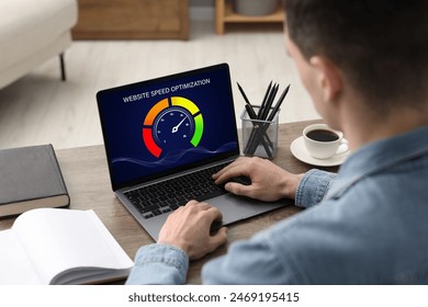 Website speed optimization. Man using laptop at table, closeup - Powered by Shutterstock