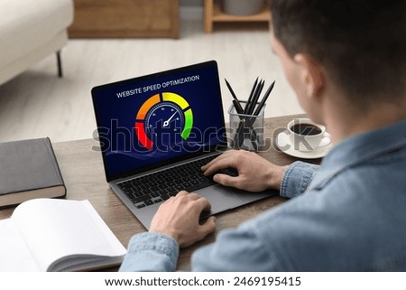 Website speed optimization. Man using laptop at table, closeup