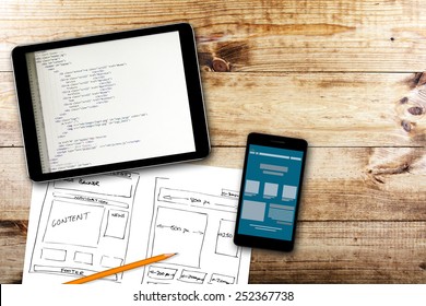 website wireframe sketch and programming code on digital tablet - Shutterstock ID 252367738