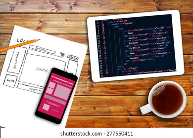 website wireframe sketch and programming code on digital tablet - Powered by Shutterstock