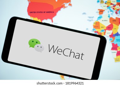 WeChat Logo Display On A Smartphone With Word Map As The Background. SEP 23, 2020: Bangalore, India.
